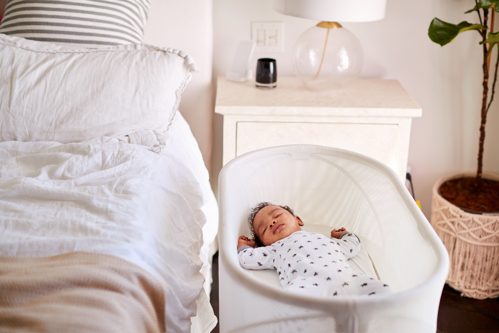 Little baby sleping in a white cot